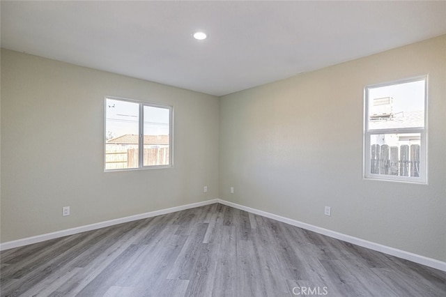 empty room with light hardwood / wood-style flooring