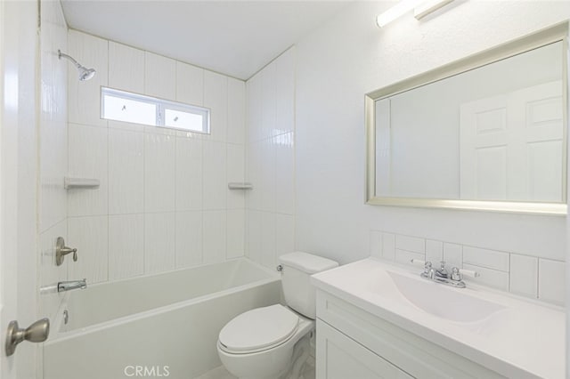 full bathroom featuring vanity, toilet, and tiled shower / bath