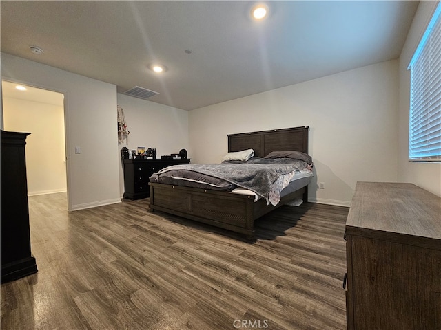 bedroom with dark hardwood / wood-style flooring