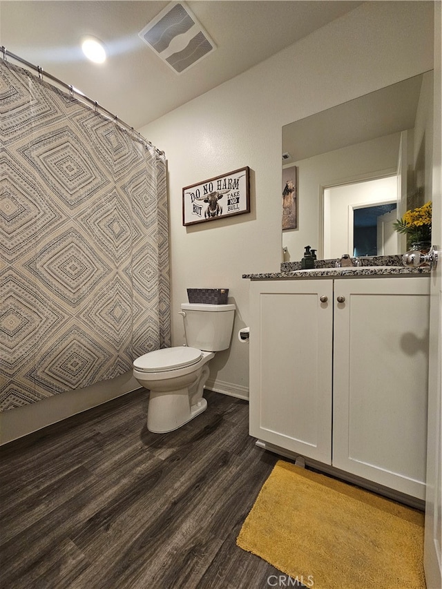 bathroom with vanity, hardwood / wood-style floors, and toilet