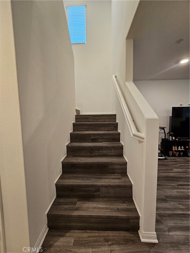 staircase featuring hardwood / wood-style flooring