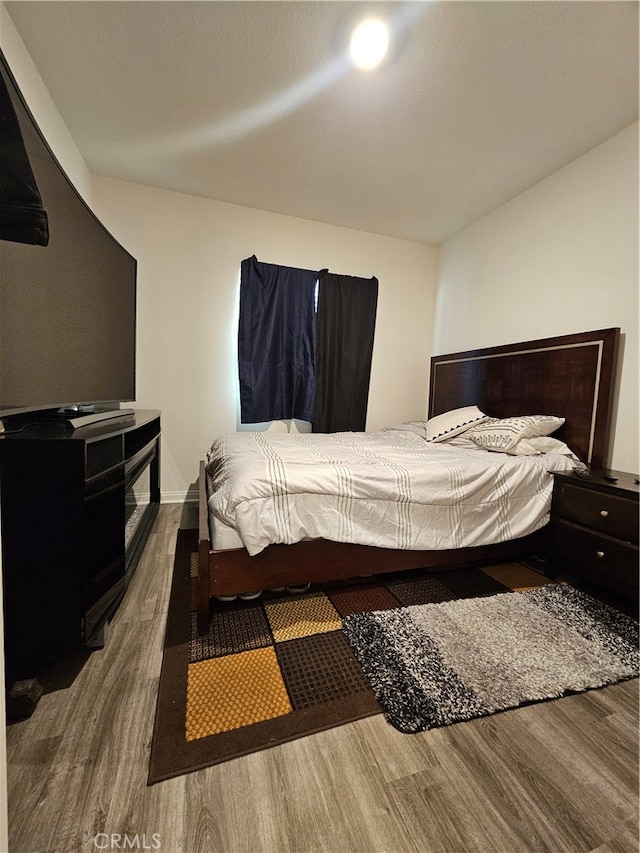 bedroom with hardwood / wood-style floors