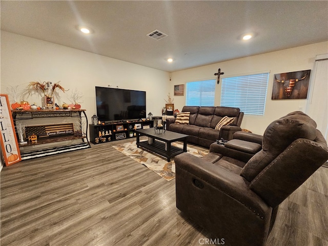 living room featuring a textured ceiling and hardwood / wood-style floors