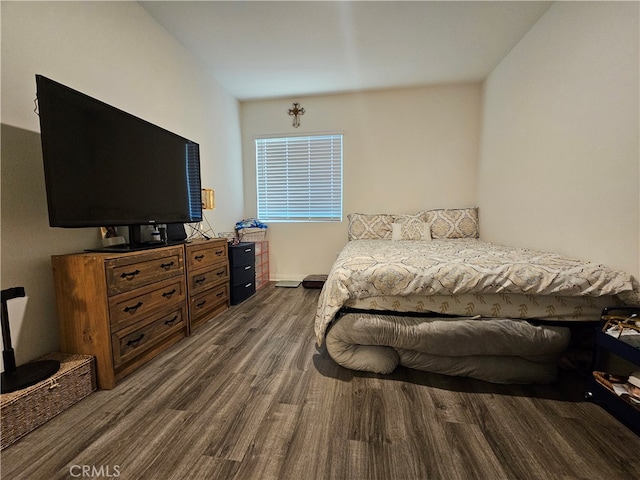 bedroom with dark hardwood / wood-style flooring