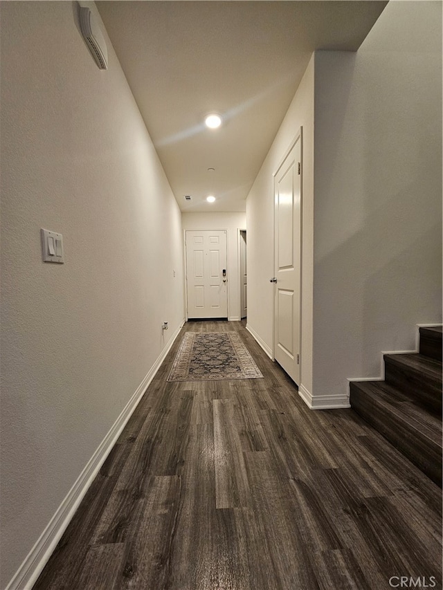 corridor with dark hardwood / wood-style floors