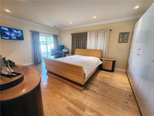 bedroom featuring light hardwood / wood-style flooring and crown molding