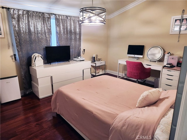 bedroom featuring built in desk, dark wood-type flooring, ornamental molding, and a chandelier