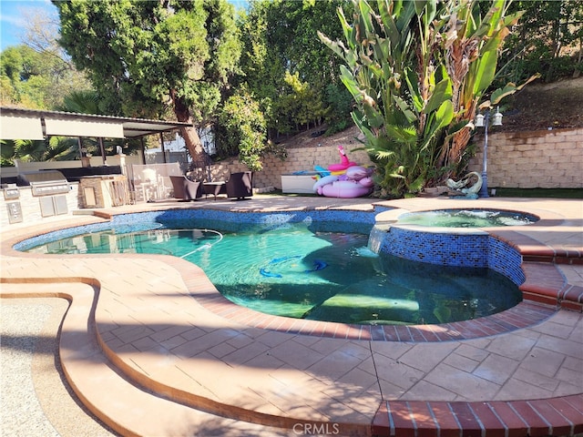 view of pool featuring a patio and an in ground hot tub