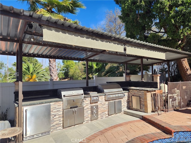 view of patio featuring a gazebo, area for grilling, and an outdoor kitchen