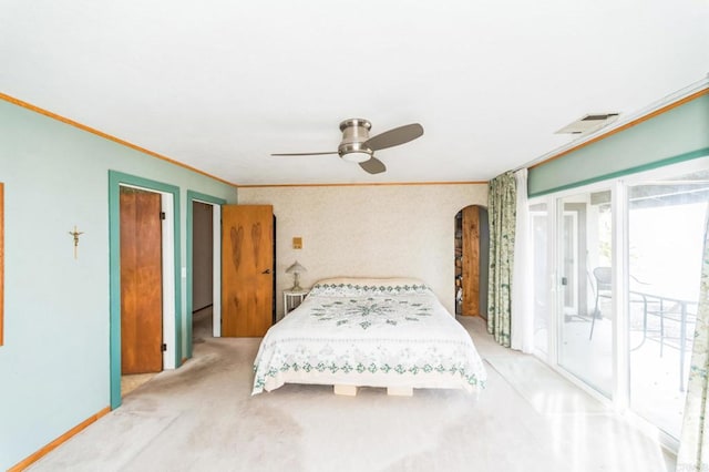 carpeted bedroom with ornamental molding, access to outside, and ceiling fan