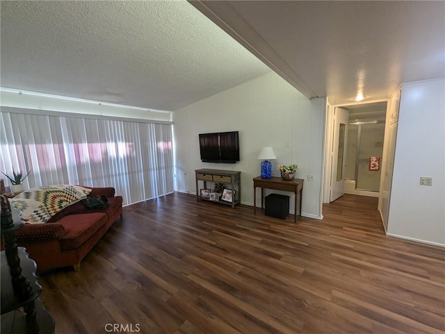 living room with dark wood-type flooring and a textured ceiling