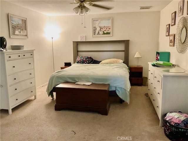 bedroom featuring light carpet and ceiling fan