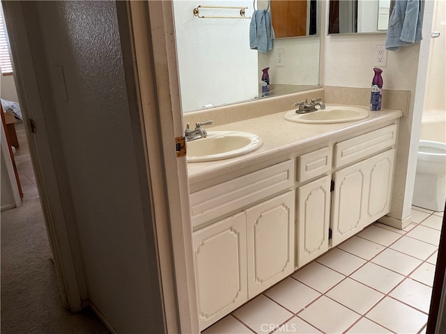 bathroom featuring vanity, toilet, and tile patterned flooring