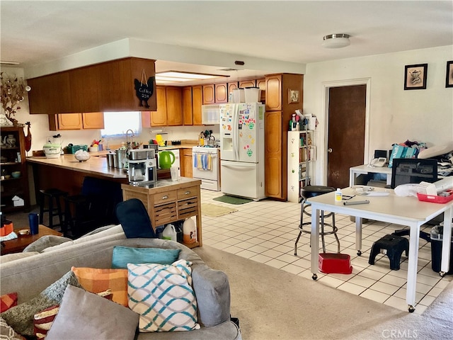 kitchen with light tile patterned floors and white appliances