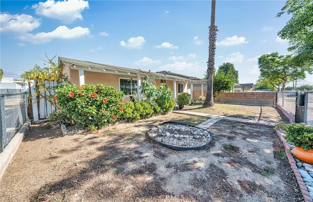 back of house featuring a fire pit