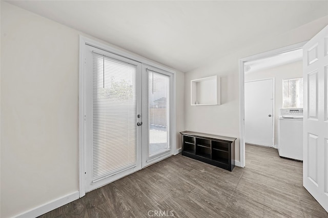 entryway featuring washer / dryer, a healthy amount of sunlight, and light wood-type flooring