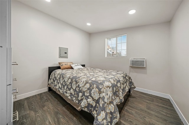 bedroom featuring dark hardwood / wood-style floors and a wall mounted air conditioner