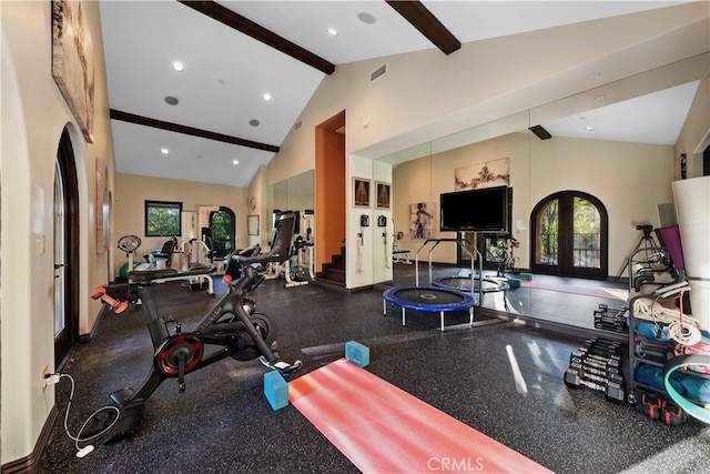 exercise room with high vaulted ceiling, french doors, and a healthy amount of sunlight