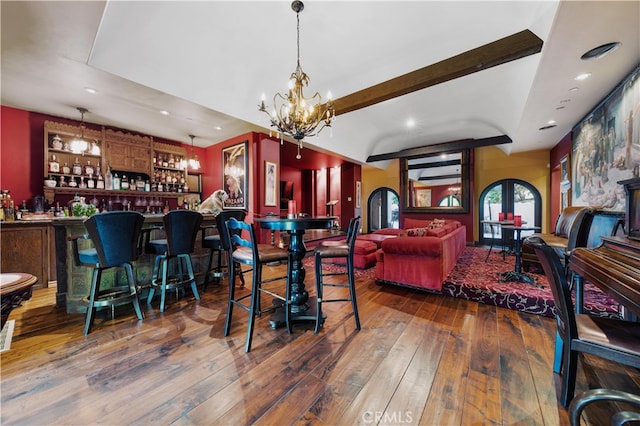 dining area with dark hardwood / wood-style flooring, french doors, indoor bar, and beamed ceiling