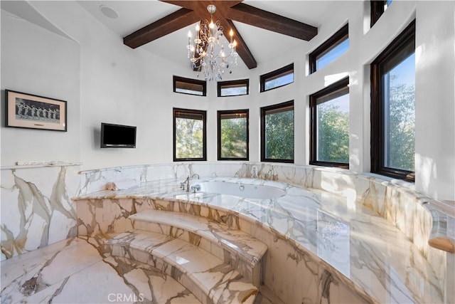 bathroom with beam ceiling, an inviting chandelier, and a washtub