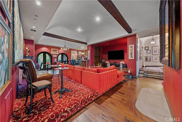 living room with hardwood / wood-style flooring and an inviting chandelier