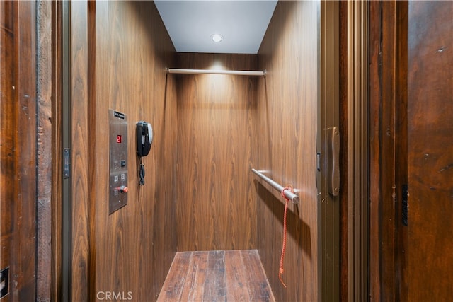 interior details featuring wooden walls and elevator