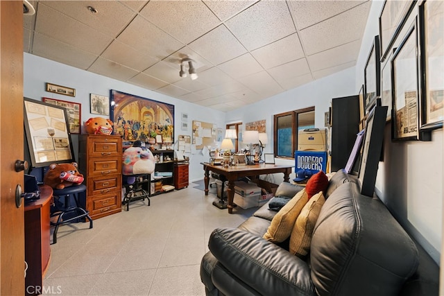 office area with a paneled ceiling