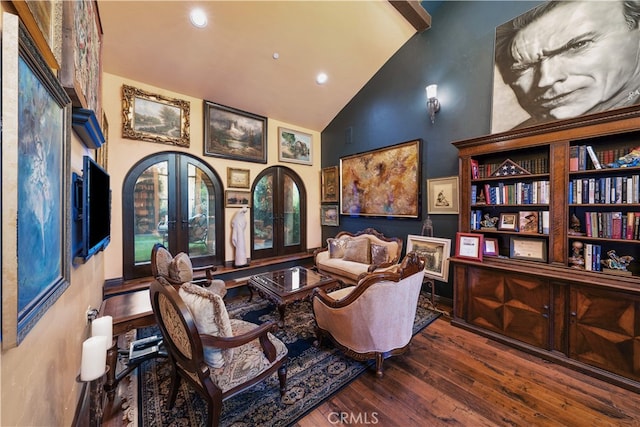 sitting room featuring high vaulted ceiling, french doors, and hardwood / wood-style floors