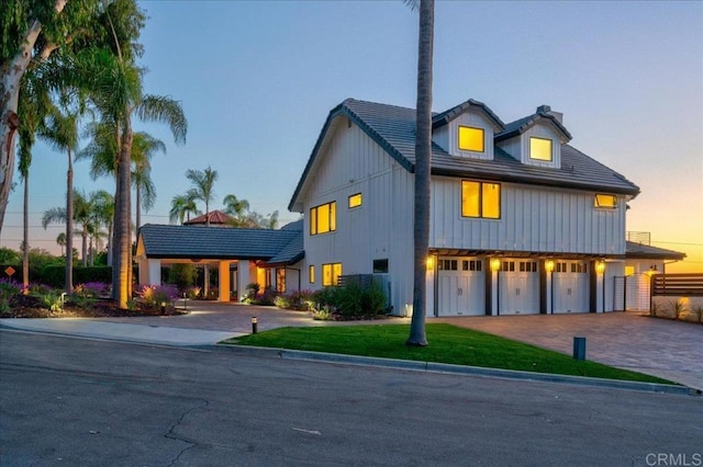 view of front of house featuring a garage and a lawn