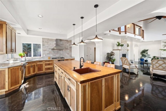 8865 San Gabriel Rd, Atascadero, CA 93422 - kitchen with butcher block counters, a sink, wall chimney exhaust hood, a raised ceiling, and tasteful backsplash