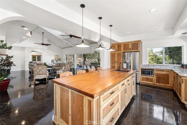 8865 San Gabriel Rd, Atascadero, CA 93422 - kitchen featuring arched walkways, a sink, ceiling fan, butcher block countertops, and stainless steel appliances