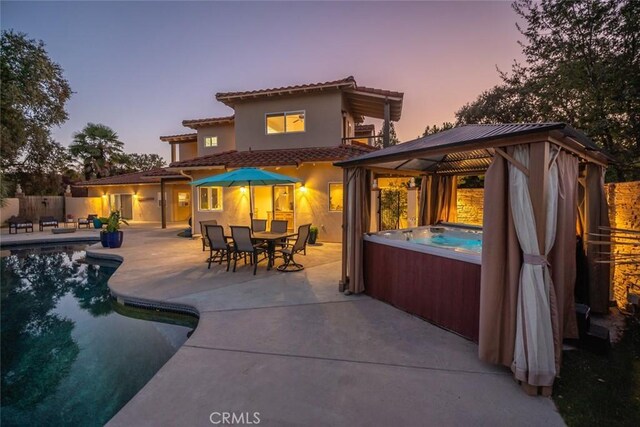 8865 San Gabriel Rd, Atascadero, CA 93422 - rear view of property featuring a hot tub, a gazebo, a patio, stucco siding, and a tiled roof