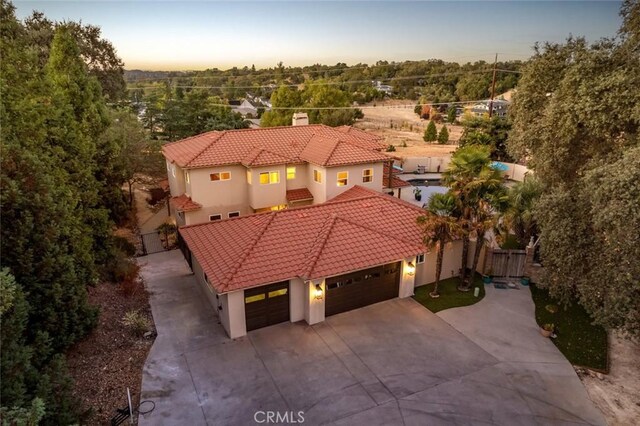 8865 San Gabriel Rd, Atascadero, CA 93422 - view of front facade featuring a tile roof, driveway, an attached garage, and stucco siding