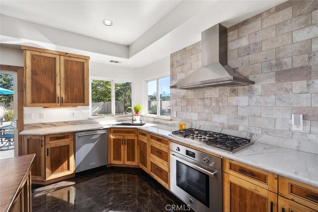 8865 San Gabriel Rd, Atascadero, CA 93422 - kitchen featuring appliances with stainless steel finishes, wall chimney range hood, a sink, and tasteful backsplash