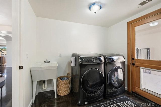 8865 San Gabriel Rd, Atascadero, CA 93422 - laundry room featuring washing machine and clothes dryer and baseboards