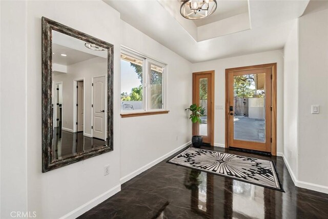 8865 San Gabriel Rd, Atascadero, CA 93422 - entrance foyer with baseboards, a chandelier, and a tray ceiling