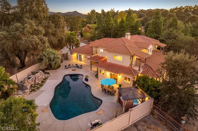 8865 San Gabriel Rd, Atascadero, CA 93422 - view of pool with a fenced backyard, a view of trees, and a patio