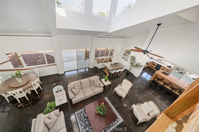 8865 San Gabriel Rd, Atascadero, CA 93422 - living area featuring healthy amount of natural light, a towering ceiling, a ceiling fan, and baseboards