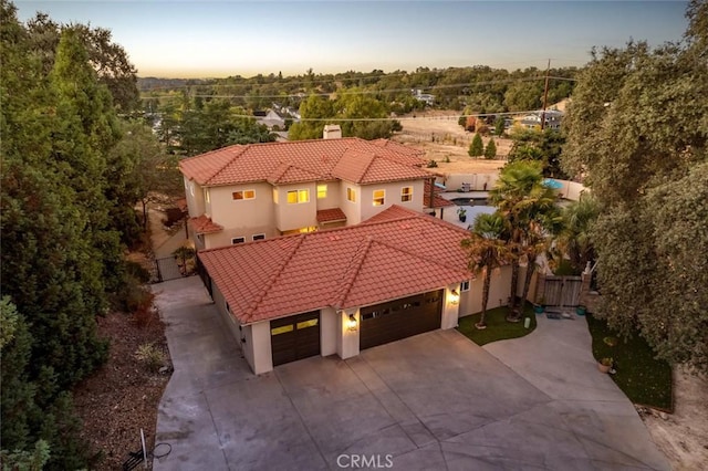 8865 San Gabriel Rd, Atascadero, CA 93422 - view of front of home with a tiled roof, concrete driveway, an attached garage, and stucco siding