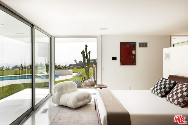 bedroom featuring a wall of windows and access to outside