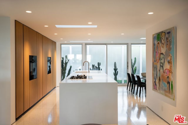 kitchen with expansive windows and white gas stovetop