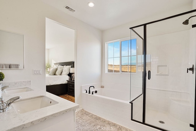 bathroom featuring vanity and separate shower and tub