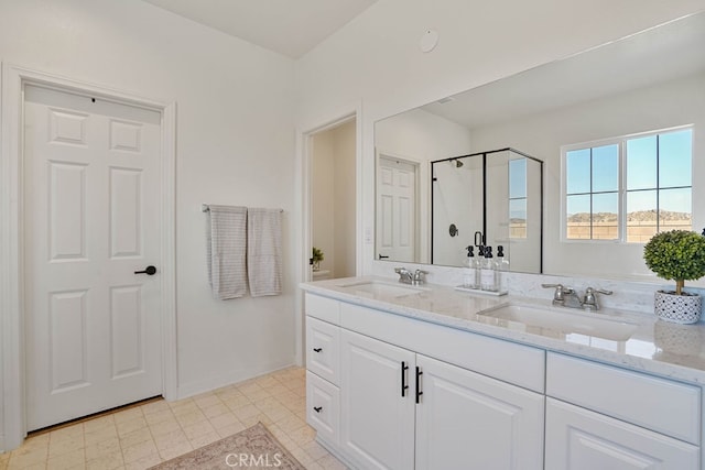 bathroom featuring vanity and an enclosed shower