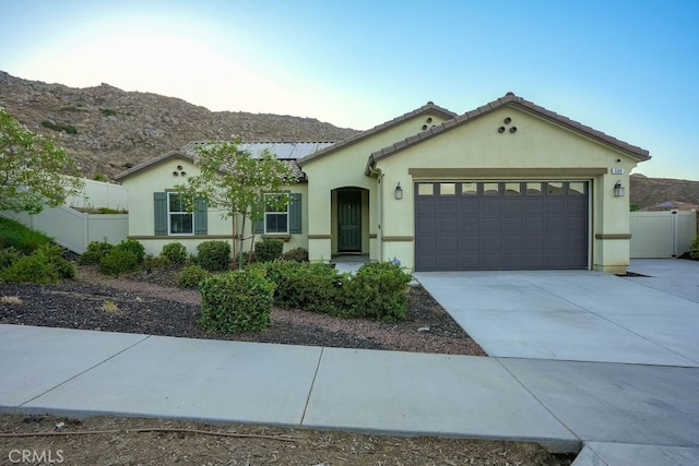 view of front of house featuring a garage and a mountain view