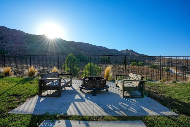 exterior space featuring a mountain view and a fire pit