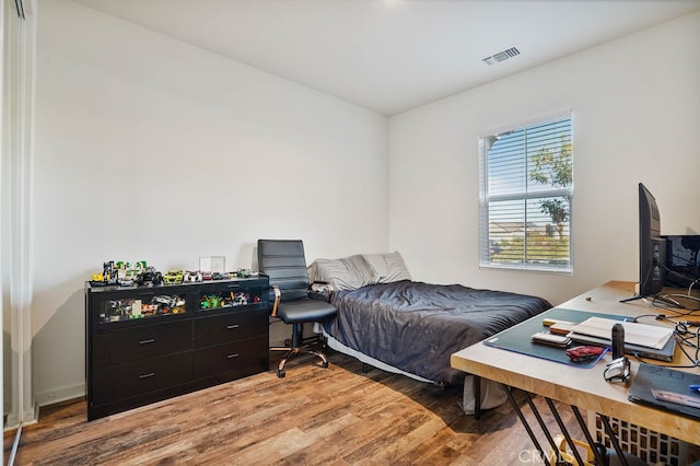 bedroom with hardwood / wood-style flooring