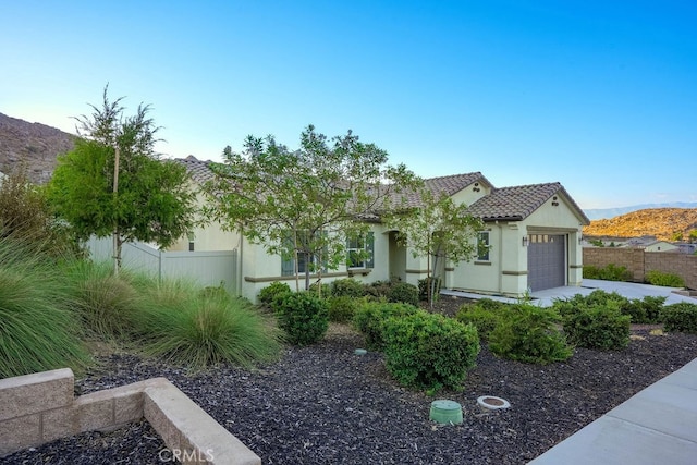 view of front of home featuring a mountain view and a garage