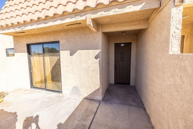 doorway to property featuring a patio