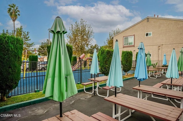 deck with a playground and a patio