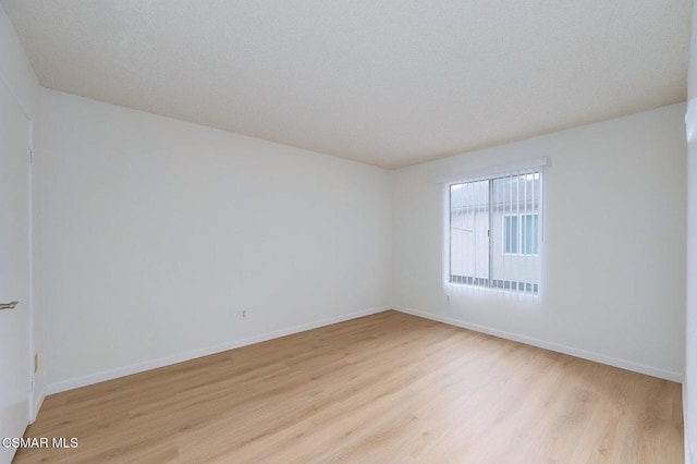 spare room with light hardwood / wood-style floors